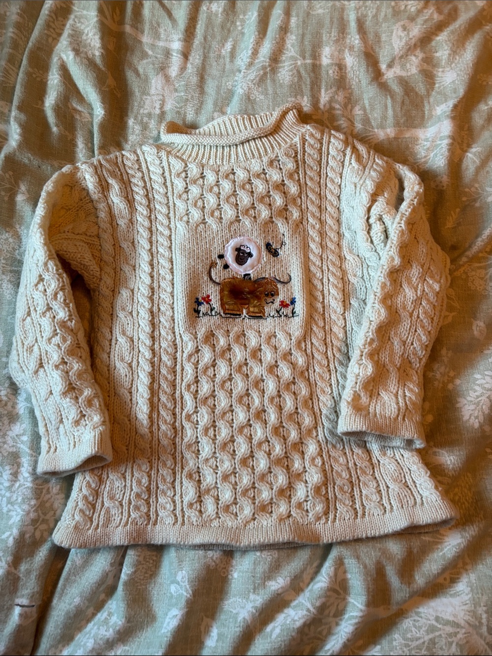 Aran Crafts Cream Cable-Knit Turtleneck Sweater with Embroidered Patch